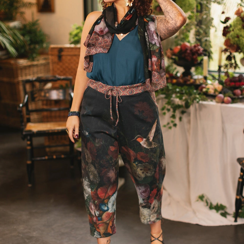 
                  
                    Model wearing the Folklore Artist Pant featuring the Bird-of-Peace embroidery and unfinished William Morris textile designs—artful linen blend pants by Market of Stars.
                  
                