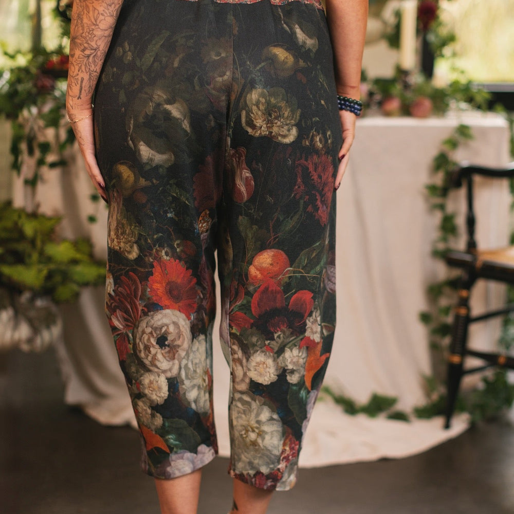 
                  
                    Model wearing the Folklore Artist Pant featuring the Bird-of-Peace embroidery and unfinished William Morris textile designs—artful linen blend pants by Market of Stars.
                  
                
