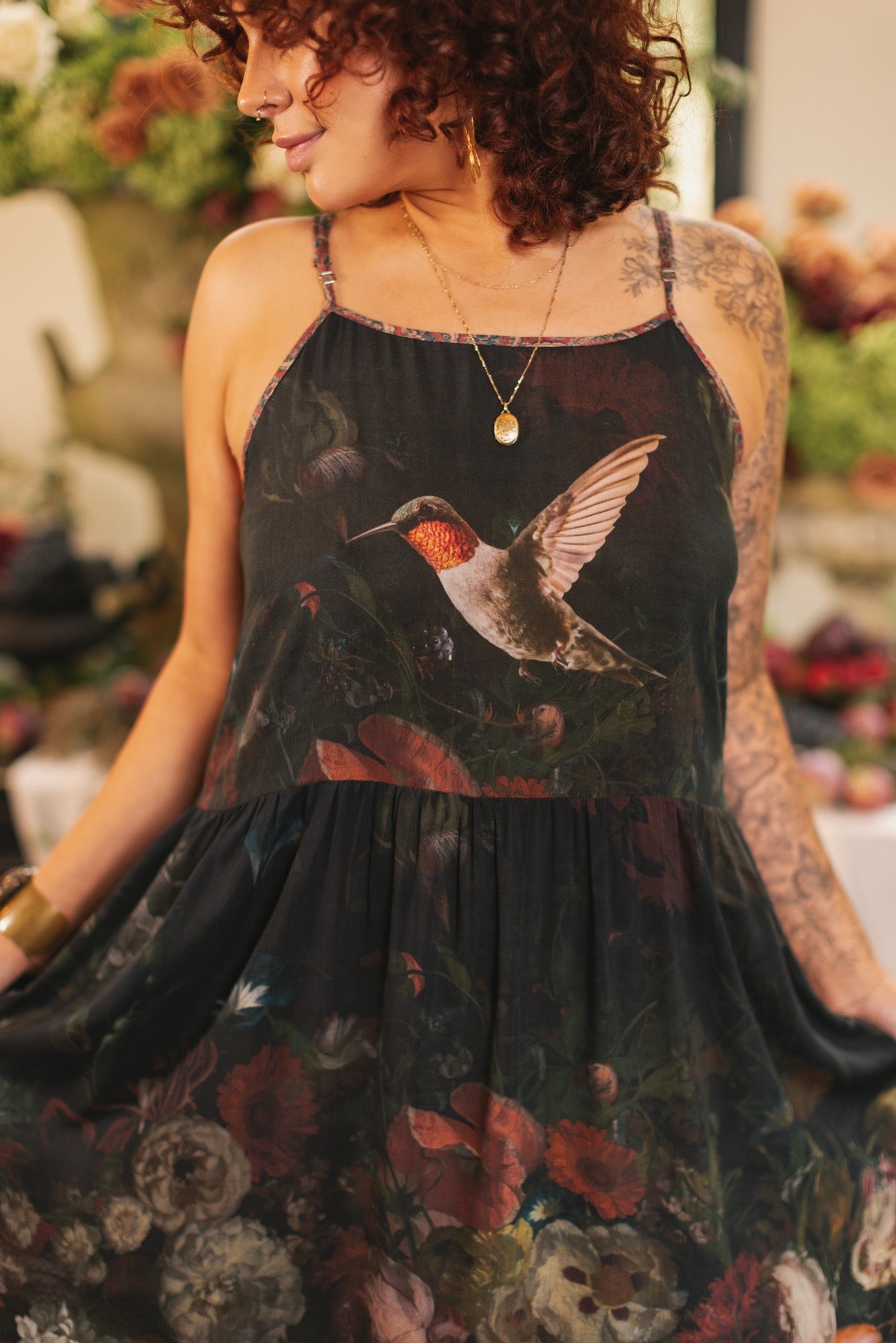 Model wearing Flight of Fancy Bohéme Slip Dress featuring hummingbirds and a vibrant floral bouquet inspired by 1700s still-life paintings by Rachel Ruysch – Market of Stars.