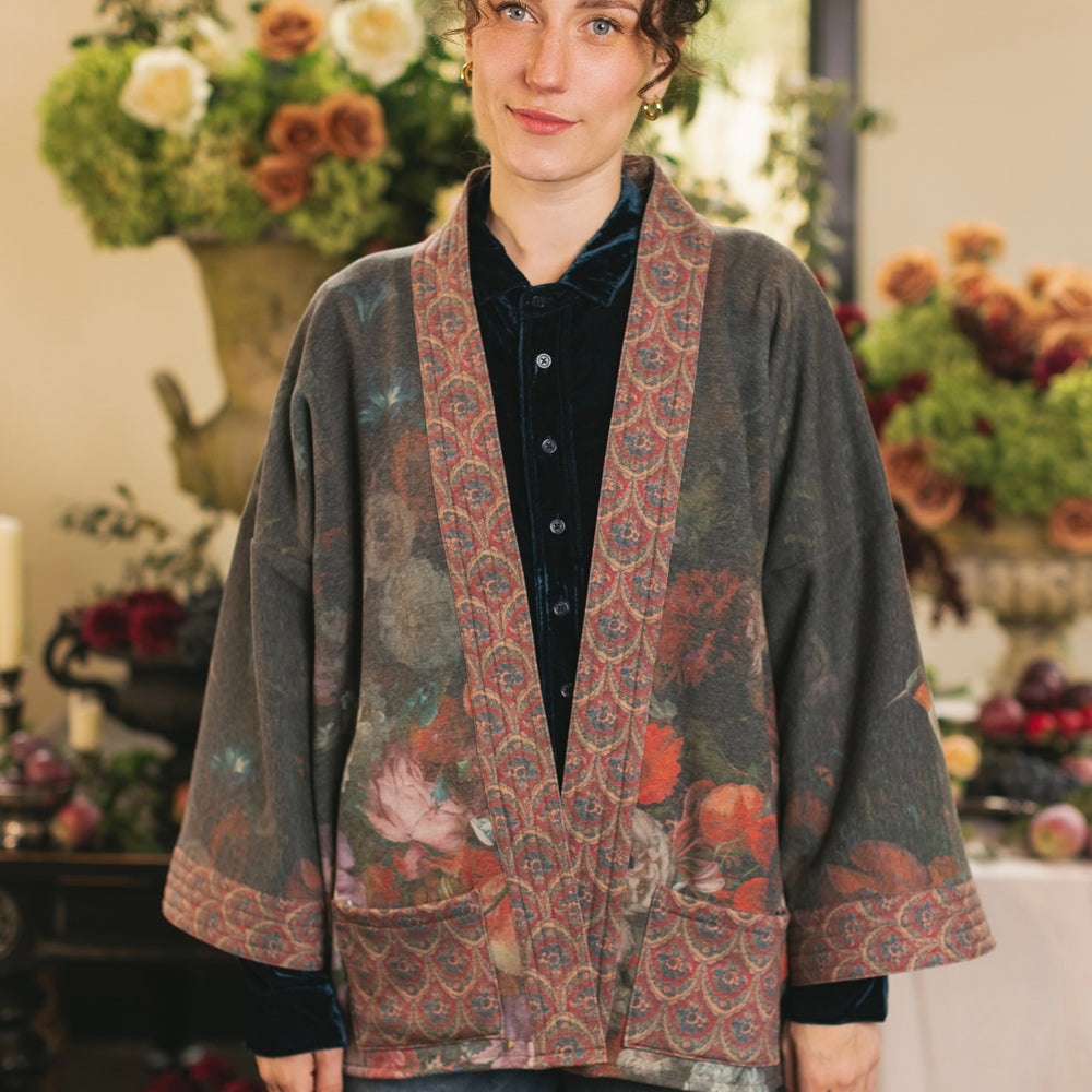
                  
                    Model wearing a cozy cardigan lined with fleece showcasing hummingbirds and 1700s floral paintings - Market of Stars
                  
                