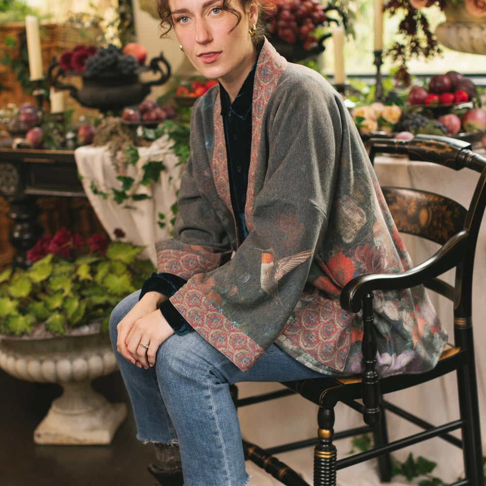 
                  
                    Model wearing a cozy cardigan lined with fleece showcasing hummingbirds and 1700s floral paintings - Market of Stars
                  
                