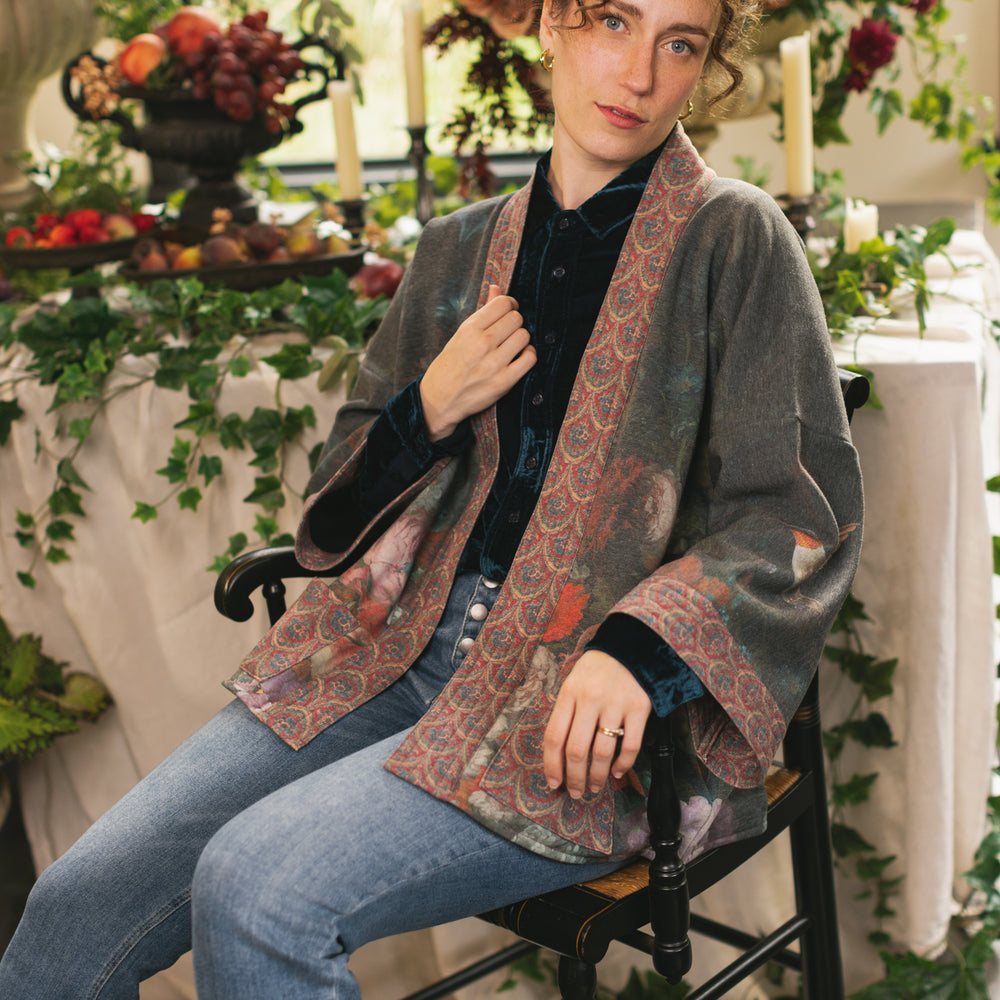 
                  
                    Model wearing a cozy cardigan lined with fleece showcasing hummingbirds and 1700s floral paintings - Market of Stars
                  
                