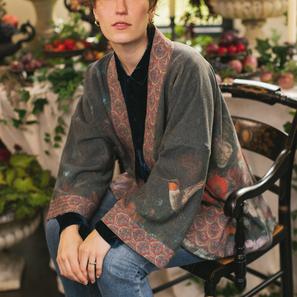 
                  
                    Model wearing a cozy cardigan lined with fleece showcasing hummingbirds and 1700s floral paintings - Market of Stars
                  
                