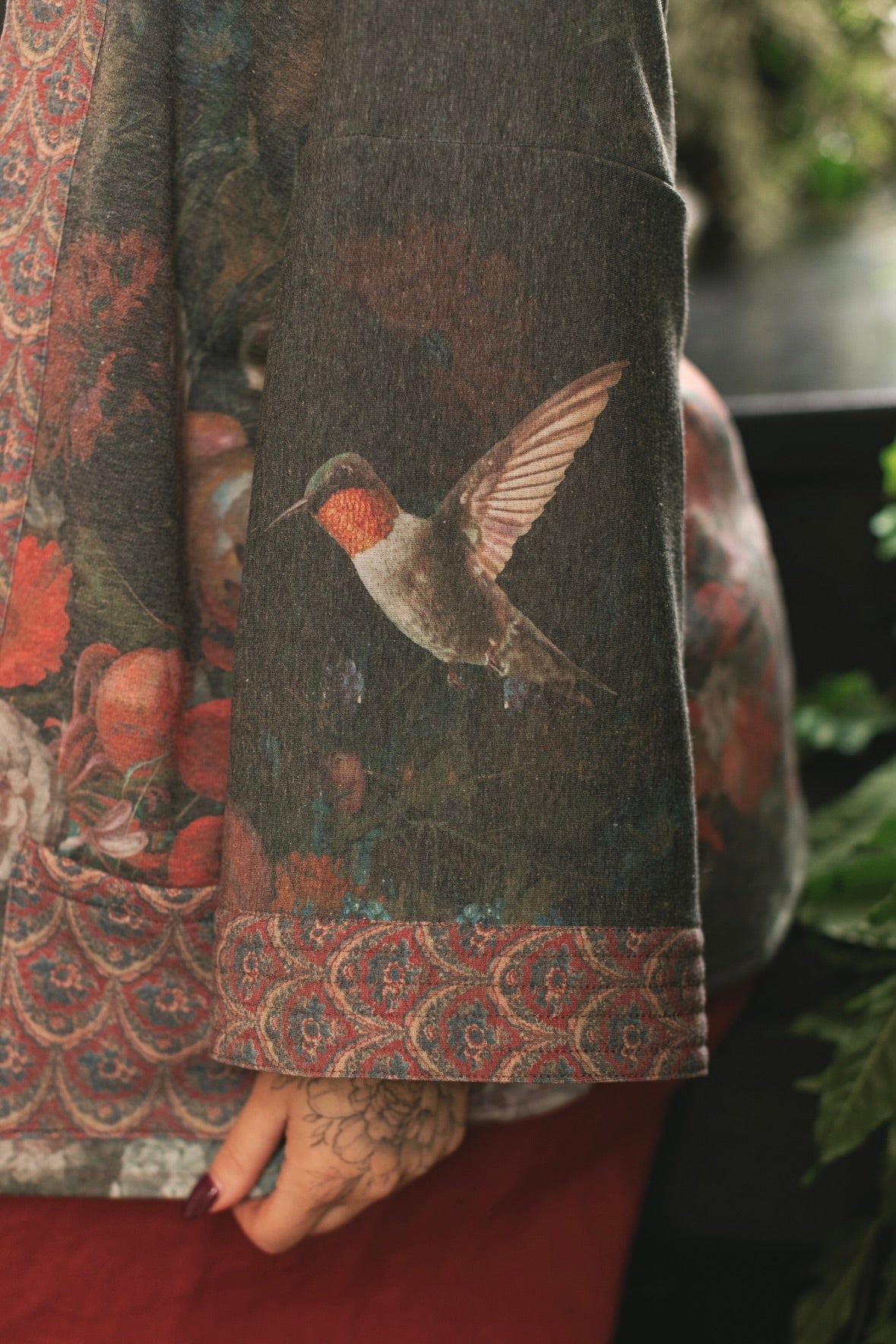 Model wearing a cozy cardigan lined with fleece showcasing hummingbirds and 1700s floral paintings - Market of Stars
