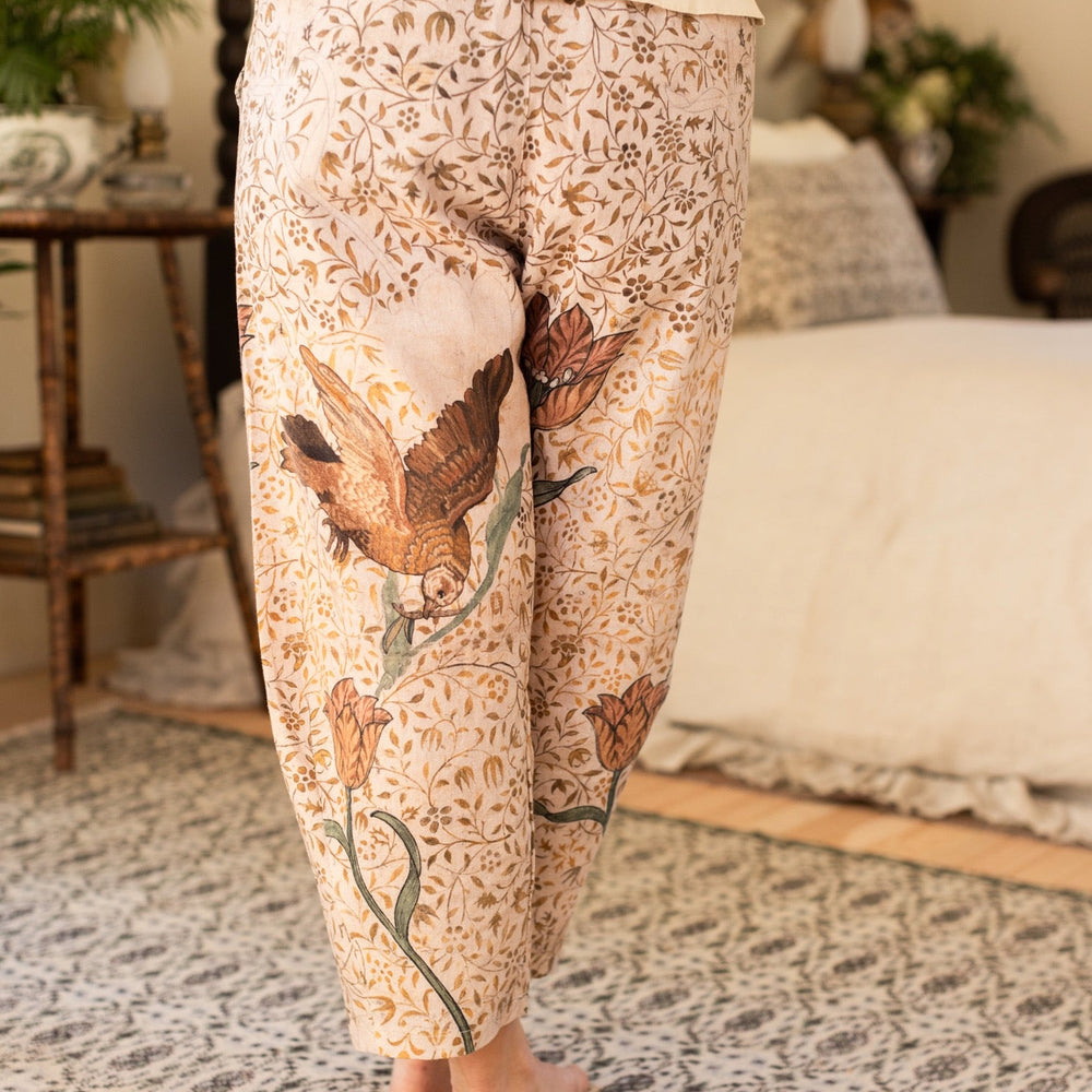 
                  
                    Model wearing Folklore Artist Pants featuring hand-stitched Bird-of-Peace embroidery and unfinished William Morris artwork celebrating the beauty of the artistic process – Market of Stars.
                  
                