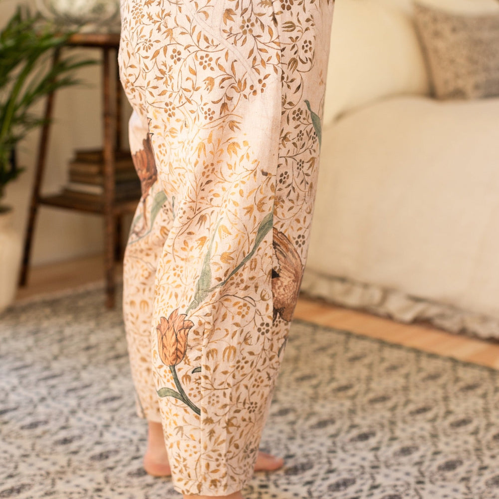 
                  
                    Model wearing Folklore Artist Pants featuring hand-stitched Bird-of-Peace embroidery and unfinished William Morris artwork celebrating the beauty of the artistic process – Market of Stars.
                  
                