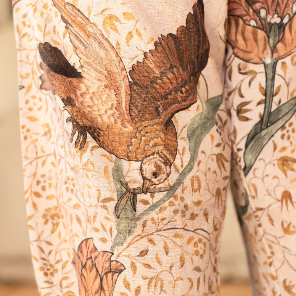
                  
                    Model wearing Folklore Artist Pants featuring hand-stitched Bird-of-Peace embroidery and unfinished William Morris artwork celebrating the beauty of the artistic process – Market of Stars.
                  
                