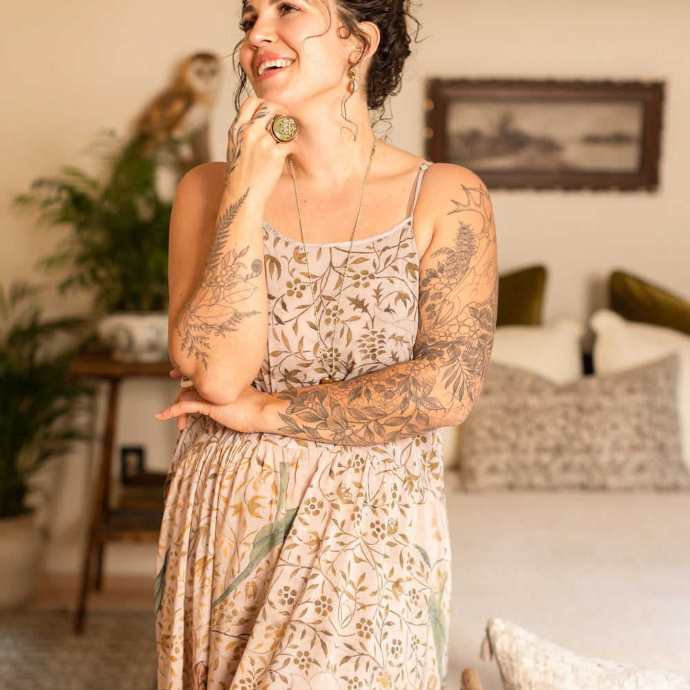 
                  
                    Model wearing Folklore Boheme slip dress featuring Bird-of-Peace embroidery and unfinished William Morris artwork in earthy romantic tones – Market of Stars.
                  
                