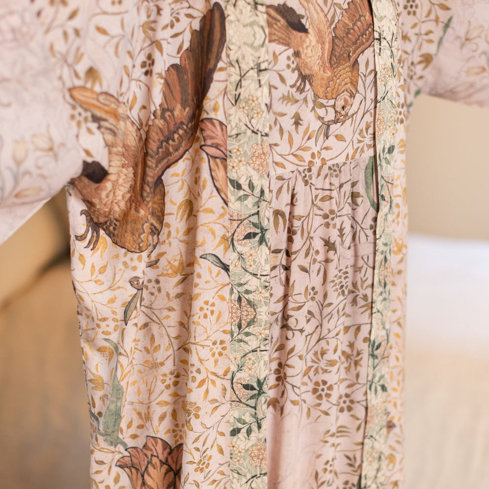 
                  
                    Model wearing Folklore Boheme slip dress featuring Bird-of-Peace embroidery and unfinished William Morris artwork in earthy romantic tones – Market of Stars.
                  
                