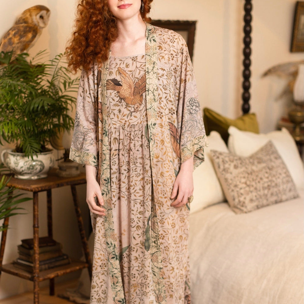 
                  
                    Model wearing Folklore Boheme slip dress featuring Bird-of-Peace embroidery and unfinished William Morris artwork in earthy romantic tones – Market of Stars.
                  
                