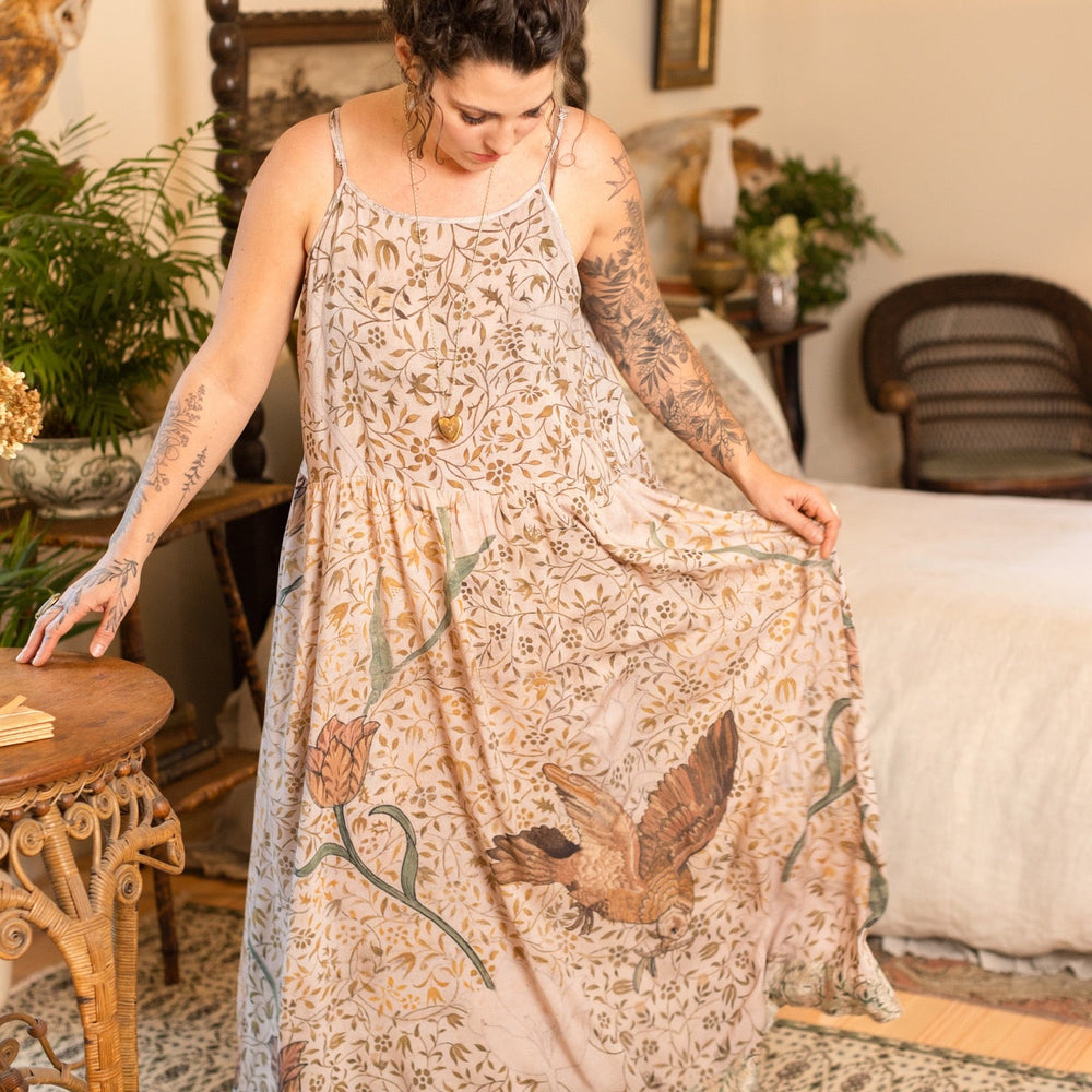 
                  
                    Model wearing Folklore Boheme slip dress featuring Bird-of-Peace embroidery and unfinished William Morris artwork in earthy romantic tones – Market of Stars.
                  
                
