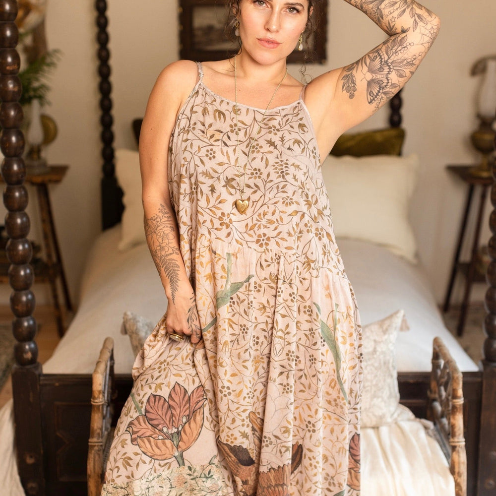 
                  
                    Model wearing Folklore Boheme slip dress featuring Bird-of-Peace embroidery and unfinished William Morris artwork in earthy romantic tones – Market of Stars.
                  
                
