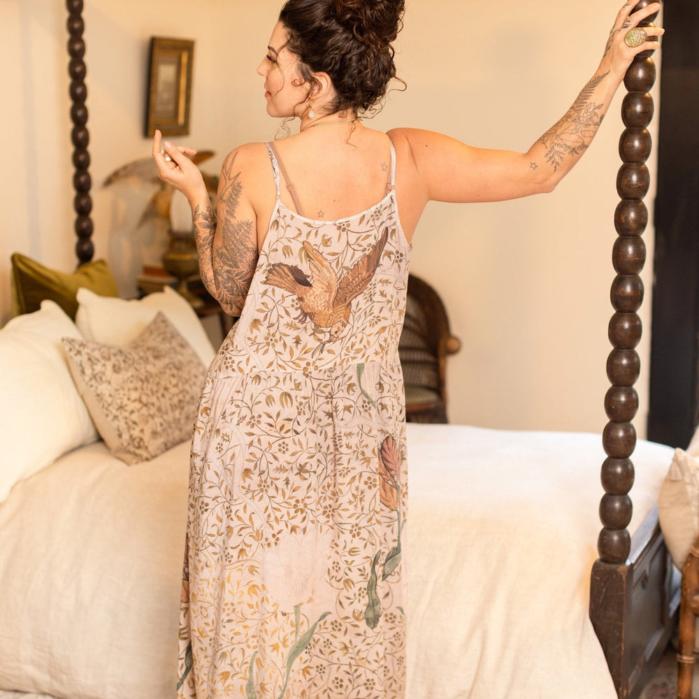 
                  
                    Model wearing Folklore Boheme slip dress featuring Bird-of-Peace embroidery and unfinished William Morris artwork in earthy romantic tones – Market of Stars.
                  
                