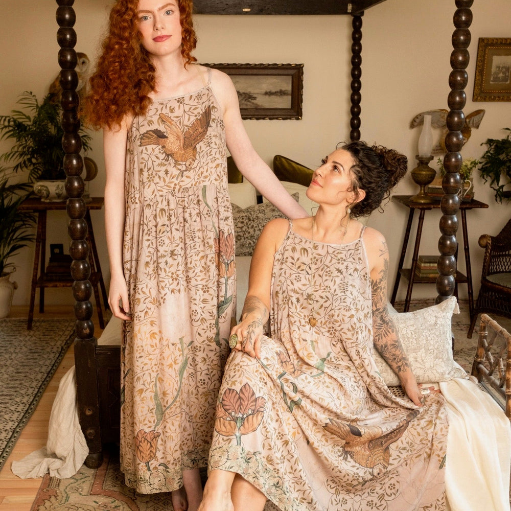 
                  
                    Model wearing Folklore Boheme slip dress featuring Bird-of-Peace embroidery and unfinished William Morris artwork in earthy romantic tones – Market of Stars.
                  
                