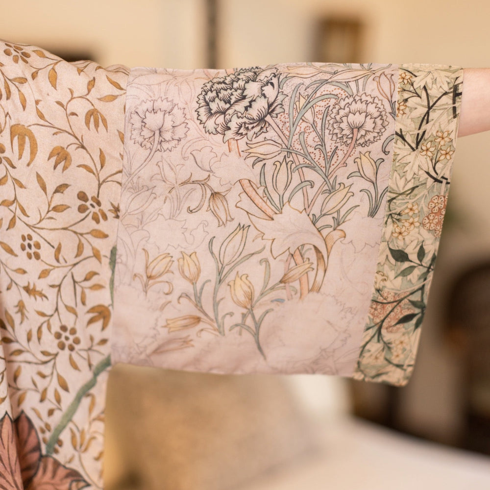 
                  
                    Model wearing opera-length kimono featuring the embroidered Bird-of-Peace by Kim Donohoe and unfinished William Morris panels celebrating artistic process – Market of Stars.
                  
                