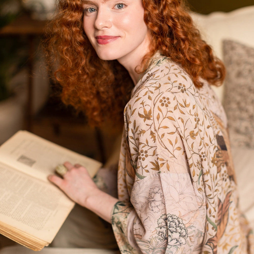 
                  
                    Model wearing full-length Folklore opera duster featuring Bird-of-Peace embroidery and unfinished William Morris textile panels in soft earthy tones – Market of Stars.
                  
                