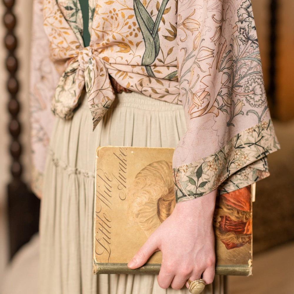 
                  
                    Model wearing full-length Folklore opera duster featuring Bird-of-Peace embroidery and unfinished William Morris textile panels in soft earthy tones – Market of Stars.
                  
                