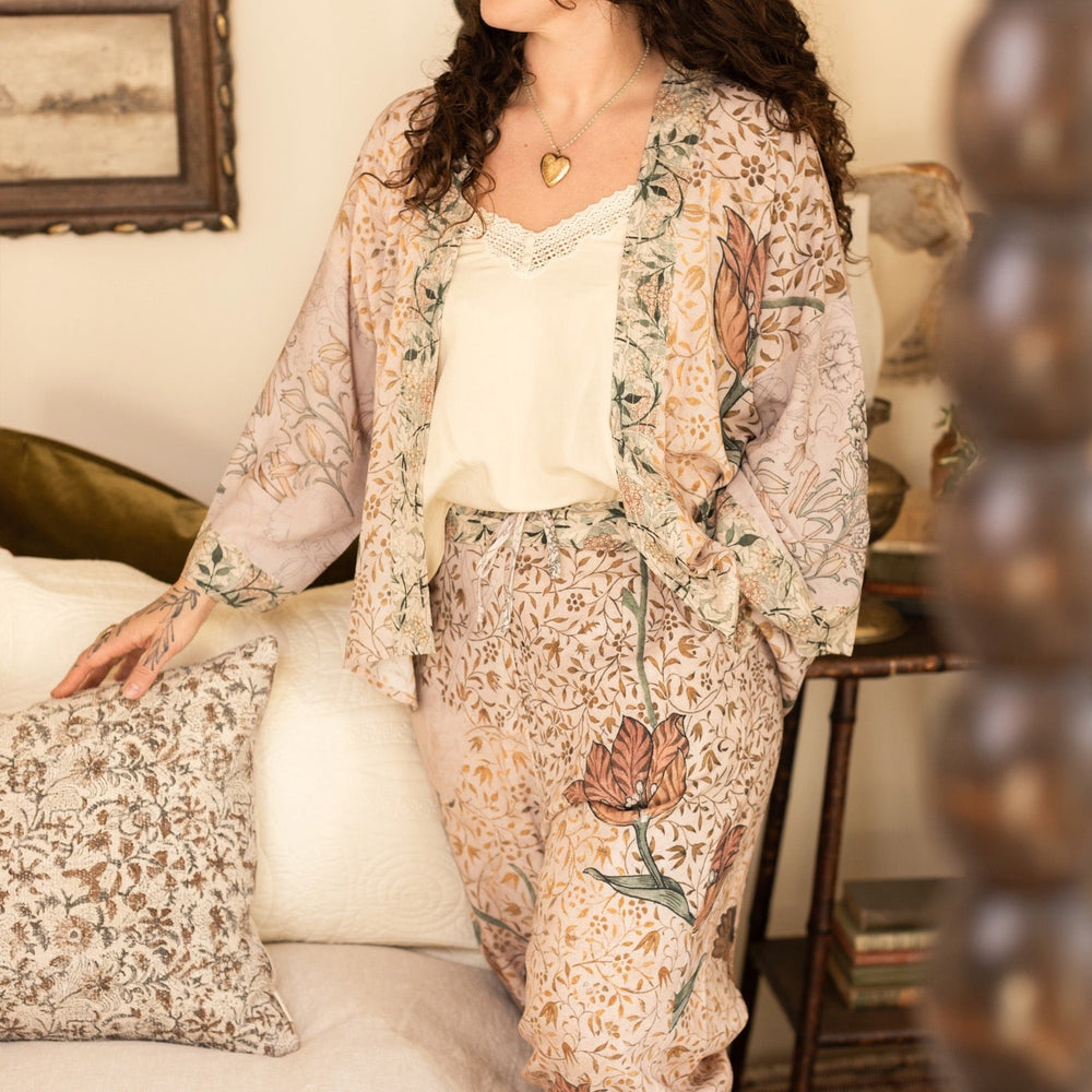 
                  
                    Model wearing full-length Folklore opera duster featuring Bird-of-Peace embroidery and unfinished William Morris textile panels in soft earthy tones – Market of Stars.
                  
                