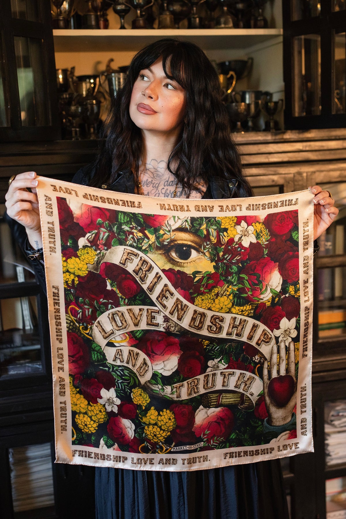 Model wearing a romantic silk scarf featuring historic symbols of love, truth, and friendship - Market of Stars