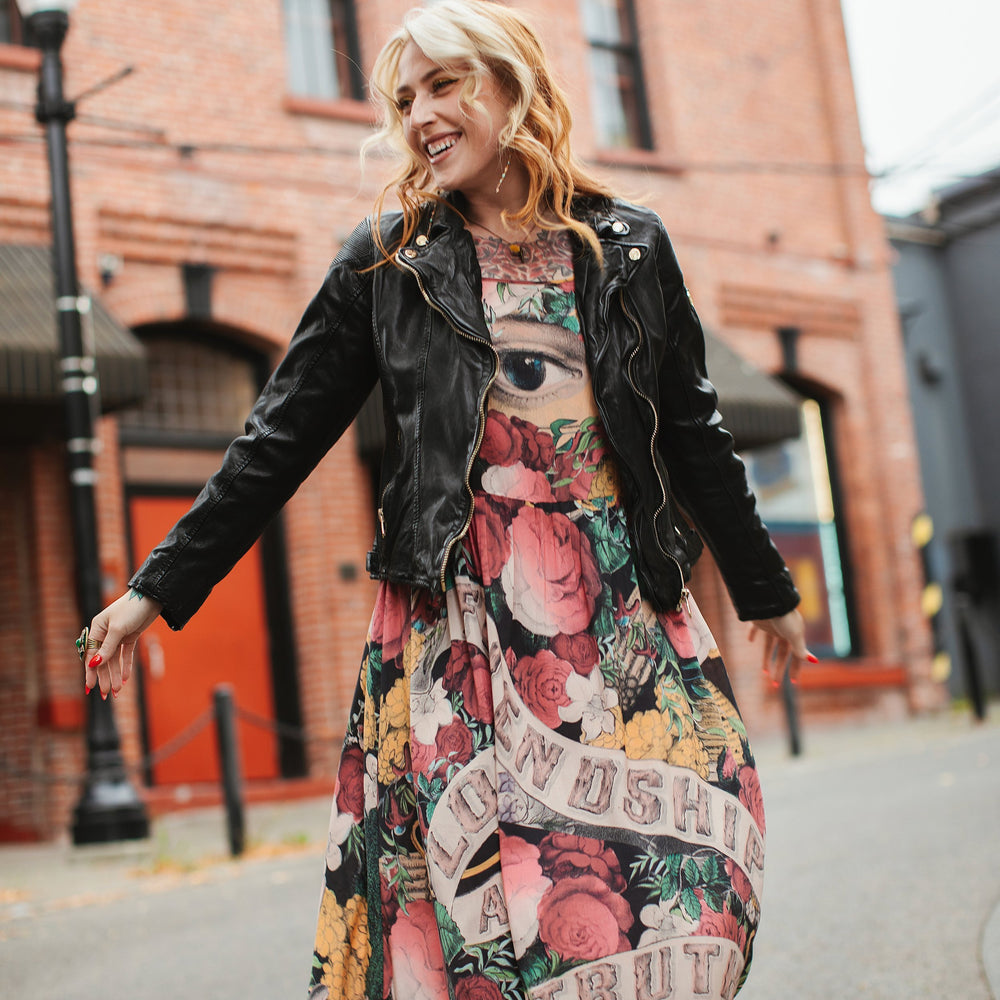 Model wearing reversible bamboo viscose slip dress featuring vintage symbols of friendship, love, and truth with pink and rose palette – Market of Stars.