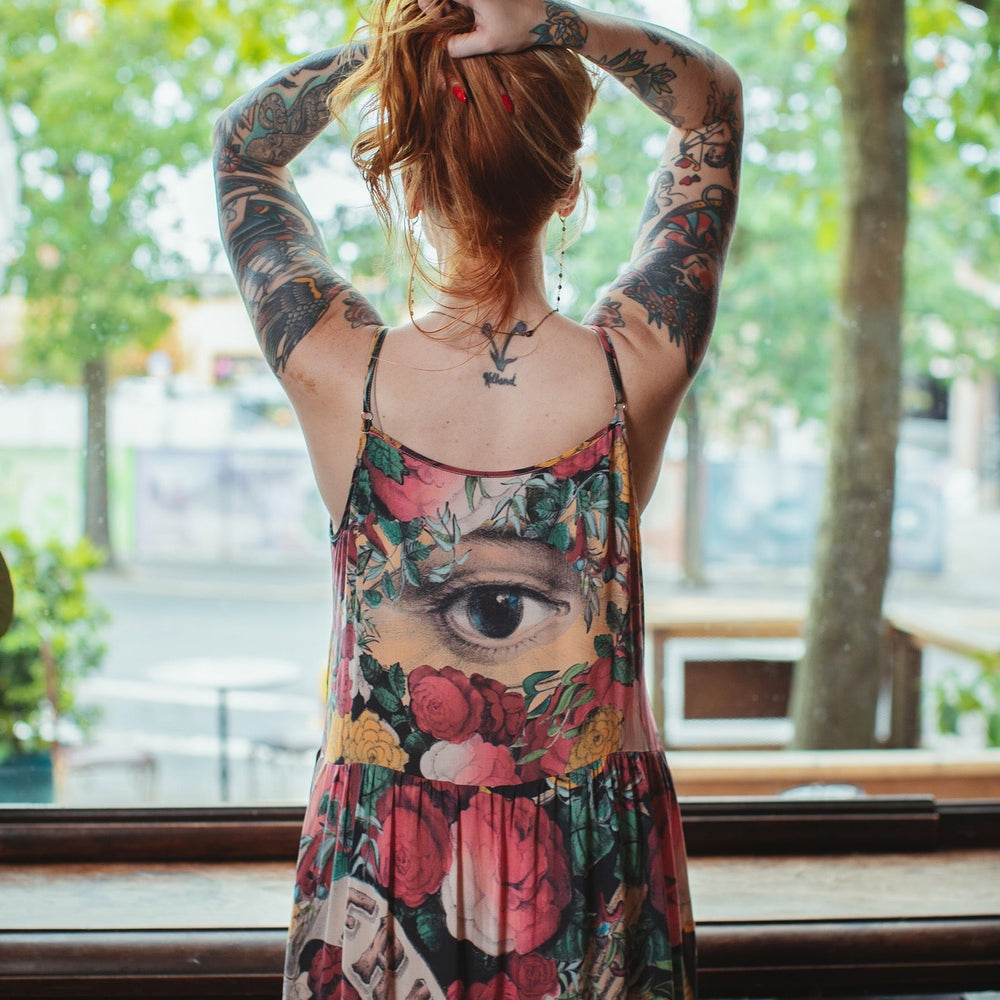 Model wearing reversible bamboo viscose slip dress featuring vintage symbols of friendship, love, and truth with pink and rose palette – Market of Stars.