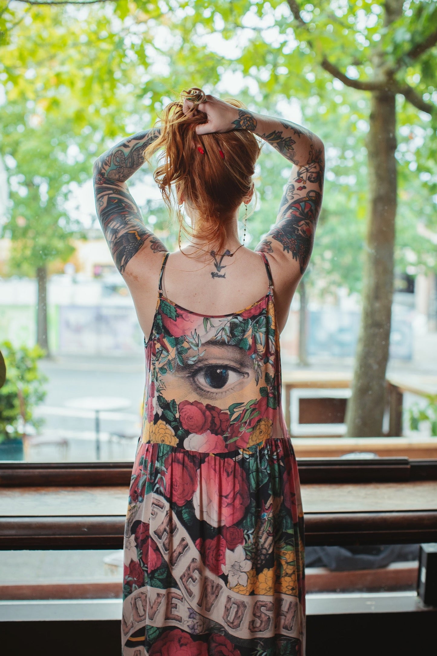 Model wearing reversible bamboo viscose slip dress featuring vintage symbols of friendship, love, and truth with pink and rose palette – Market of Stars.