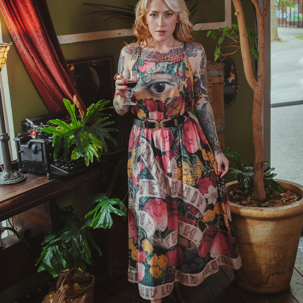 
                  
                    Model wearing reversible bamboo viscose slip dress featuring vintage symbols of friendship, love, and truth with pink and rose palette – Market of Stars.
                  
                