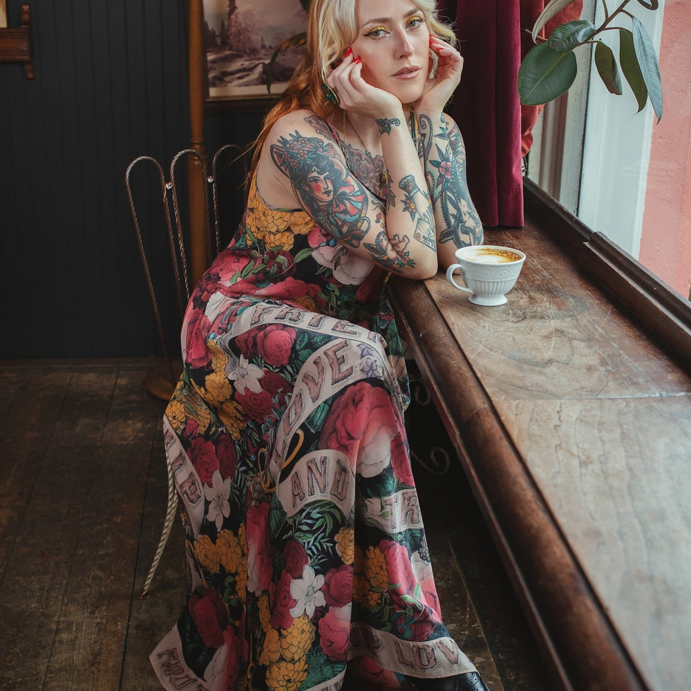 
                  
                    Model wearing reversible bamboo viscose slip dress featuring vintage symbols of friendship, love, and truth with pink and rose palette – Market of Stars.
                  
                
