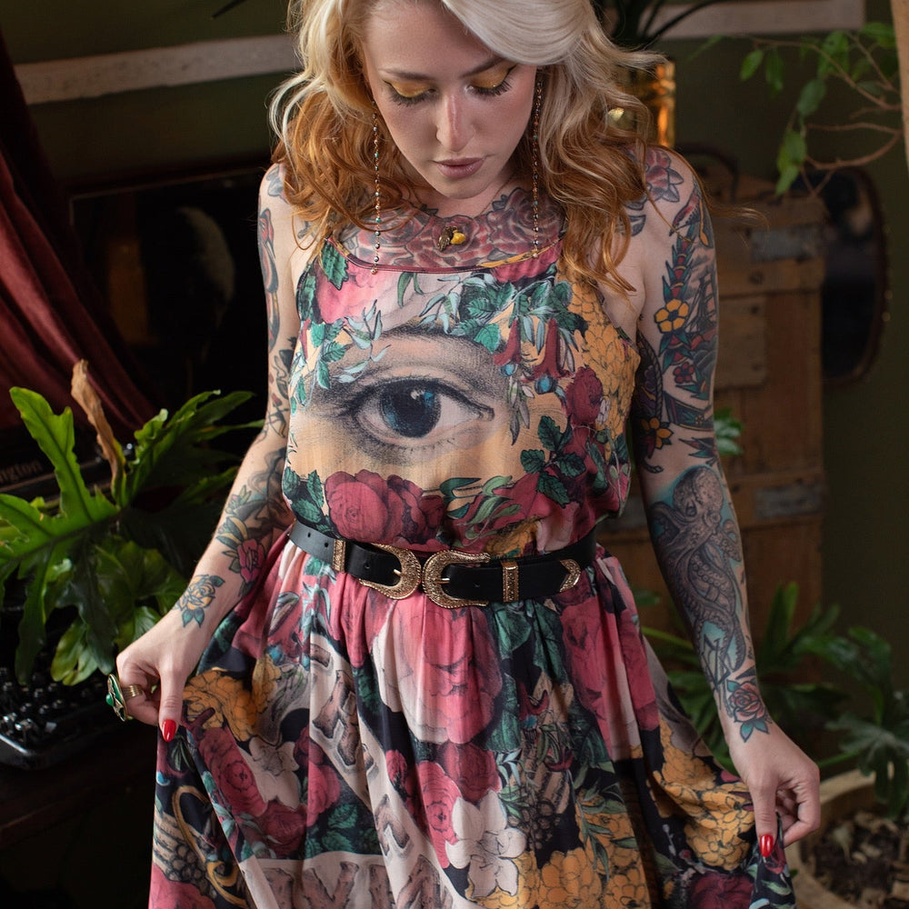 
                  
                    Model wearing reversible bamboo viscose slip dress featuring vintage symbols of friendship, love, and truth with pink and rose palette – Market of Stars.
                  
                