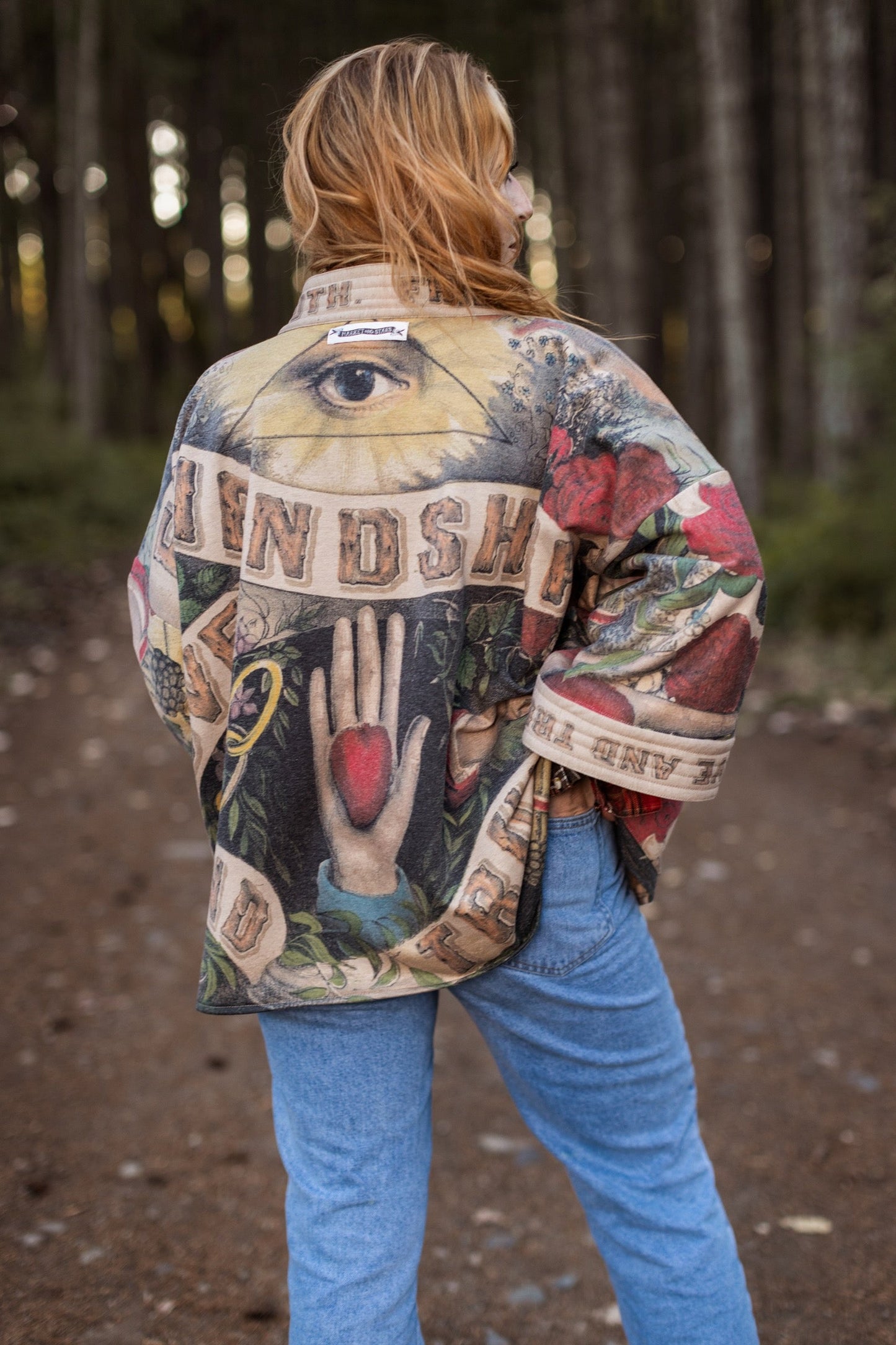 Model wearing cozy printed cardigan with vintage symbols of love, truth, and friendship, featuring charming wood-grain trim and patch pockets – Market of Stars.