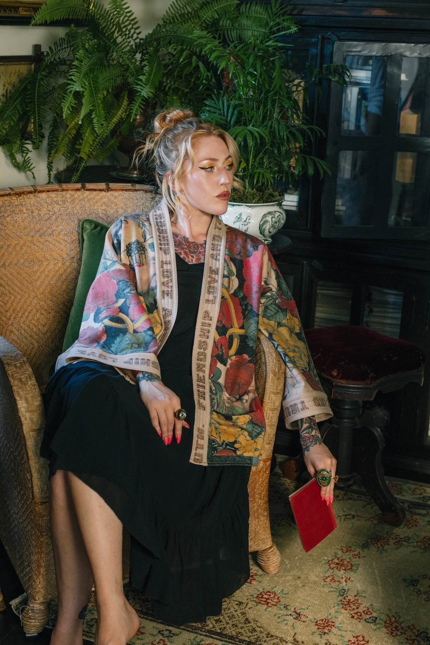Model wearing cozy printed cardigan with vintage symbols of love, truth, and friendship, featuring charming wood-grain trim and patch pockets – Market of Stars.