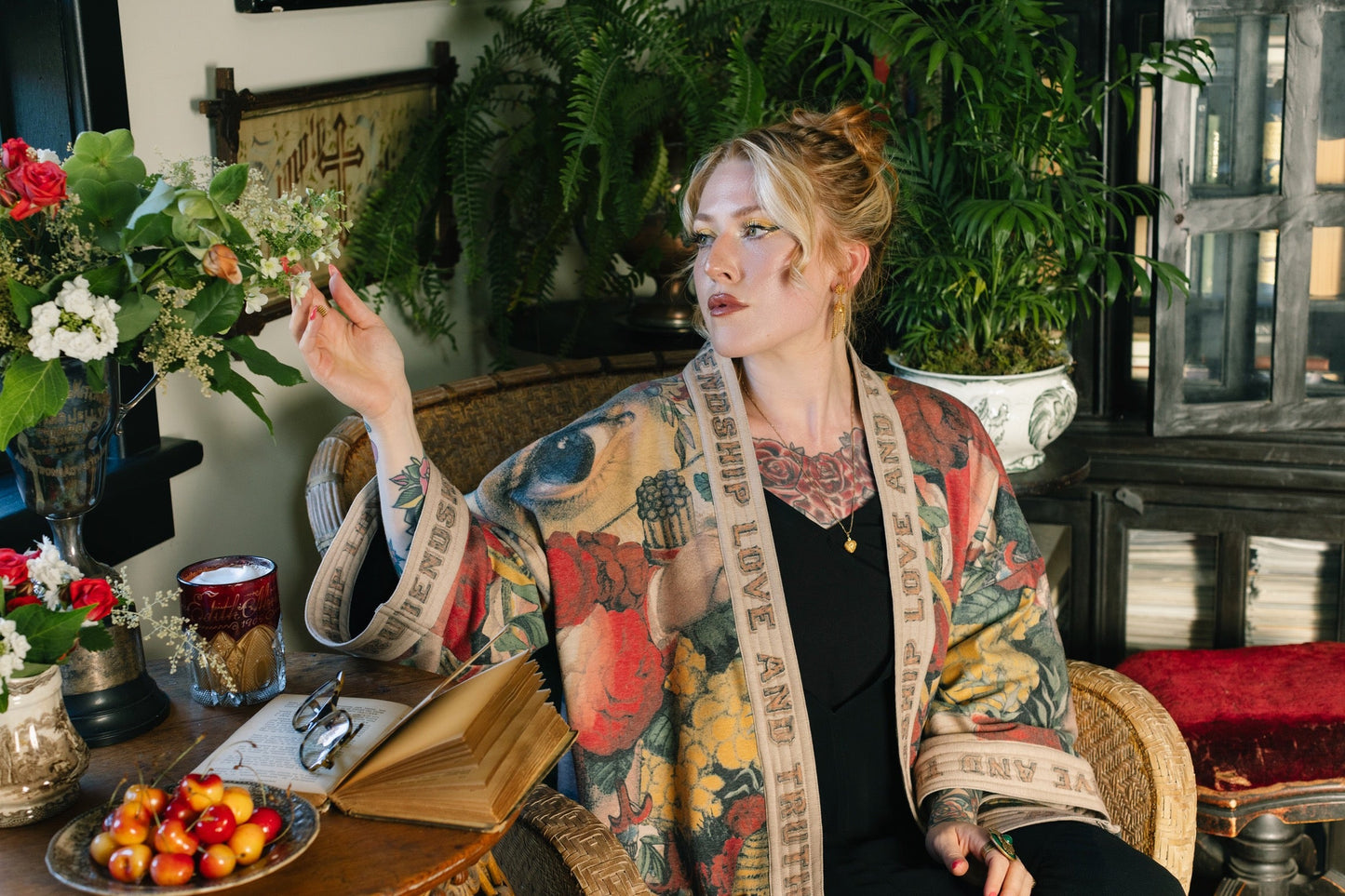 Model wearing cozy printed cardigan with vintage symbols of love, truth, and friendship, featuring charming wood-grain trim and patch pockets – Market of Stars.