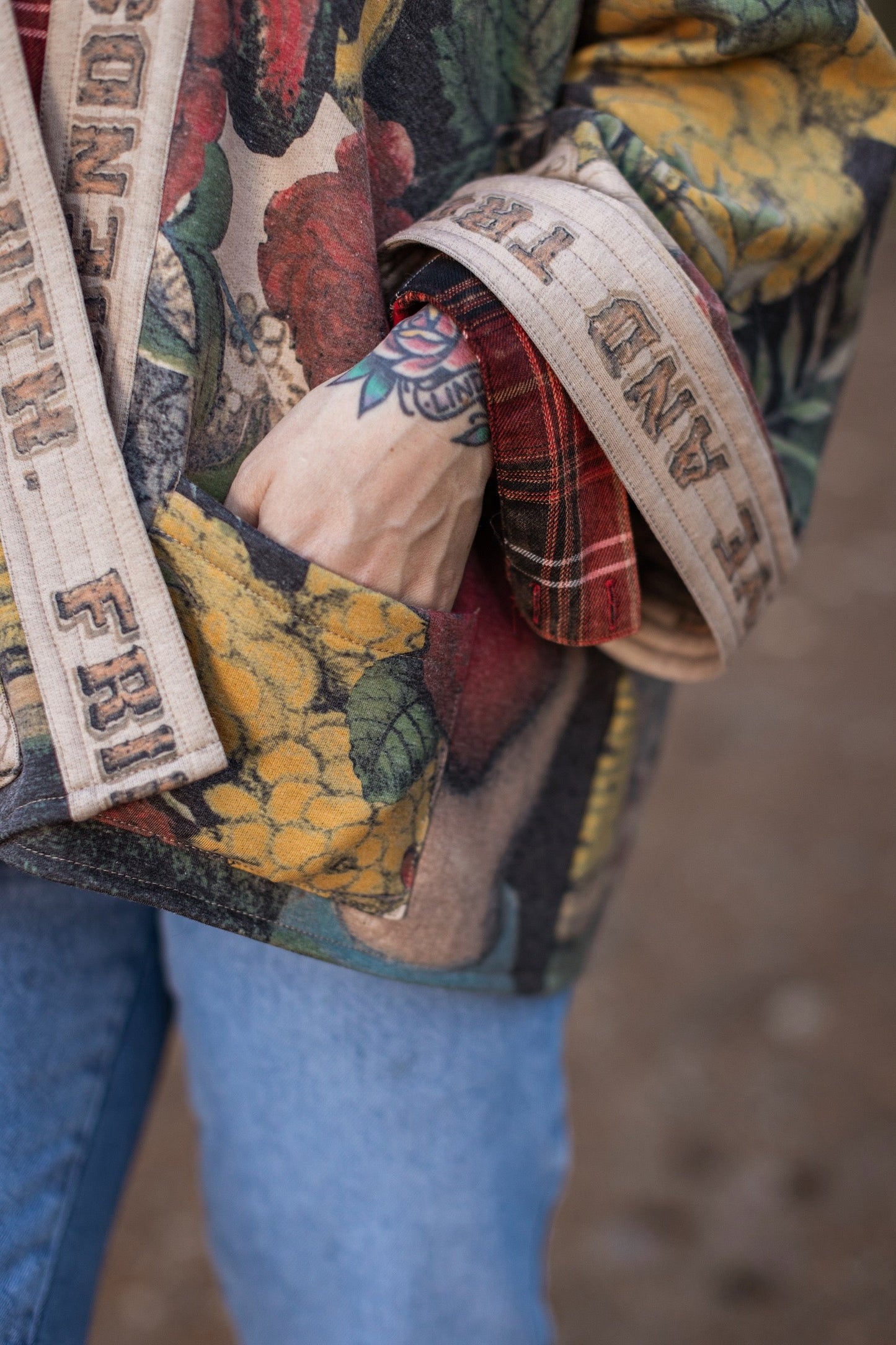 Model wearing cozy printed cardigan with vintage symbols of love, truth, and friendship, featuring charming wood-grain trim and patch pockets – Market of Stars.
