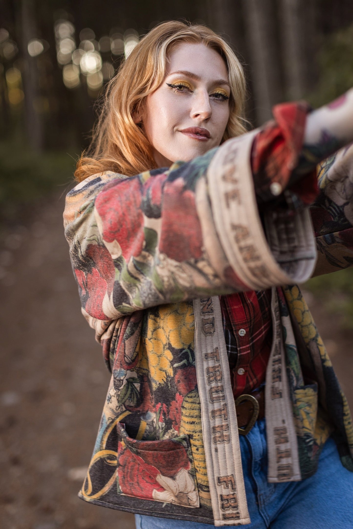 Model wearing cozy printed cardigan with vintage symbols of love, truth, and friendship, featuring charming wood-grain trim and patch pockets – Market of Stars.