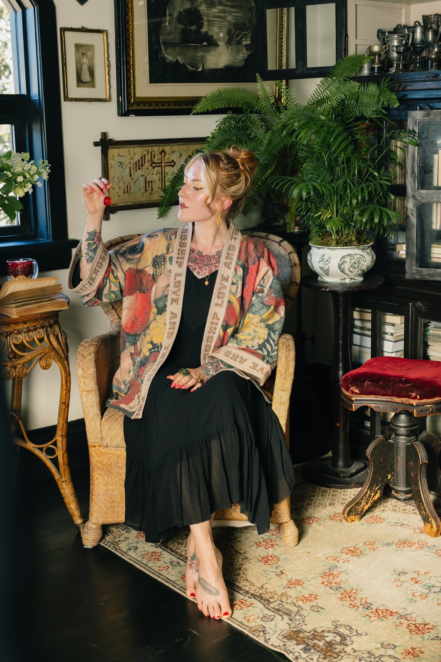 Model wearing cozy printed cardigan with vintage symbols of love, truth, and friendship, featuring charming wood-grain trim and patch pockets – Market of Stars.