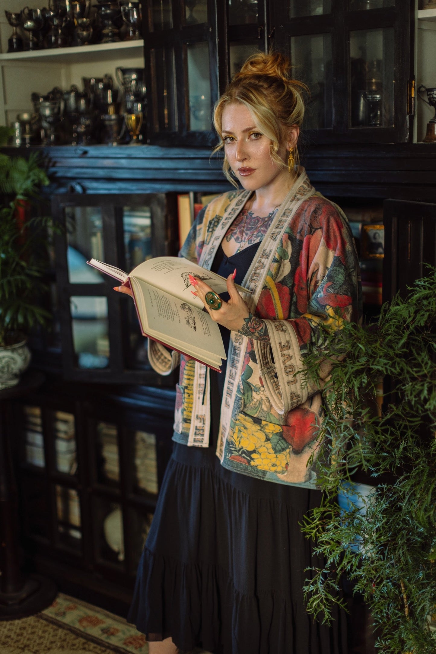 Model wearing cozy printed cardigan with vintage symbols of love, truth, and friendship, featuring charming wood-grain trim and patch pockets – Market of Stars.
