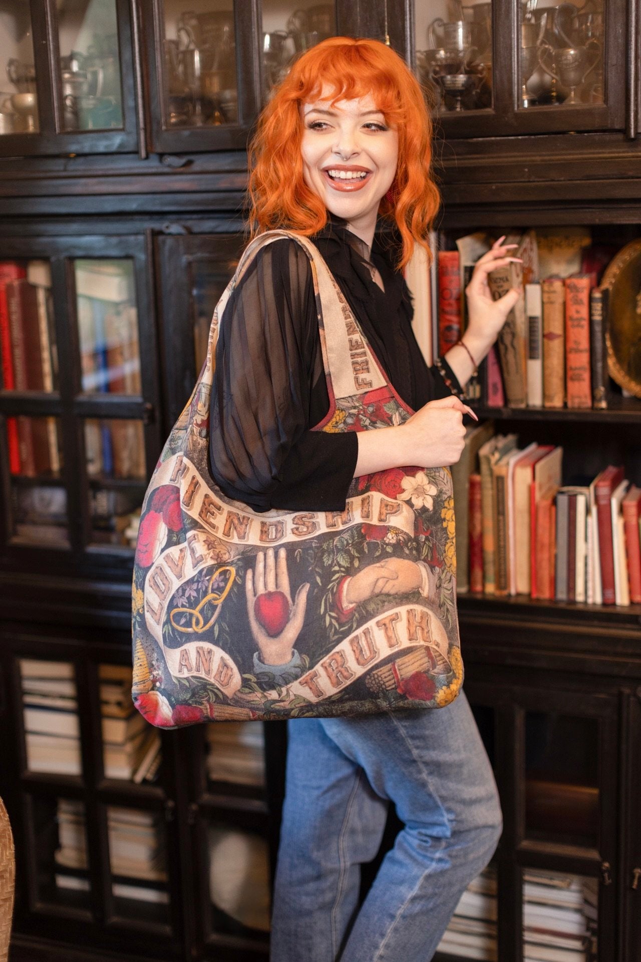 Model holding Friendship Love and Truth tote featuring historic symbols of cooperation, teamwork, eternal love, and truth from an 1880s print – Market of Stars.