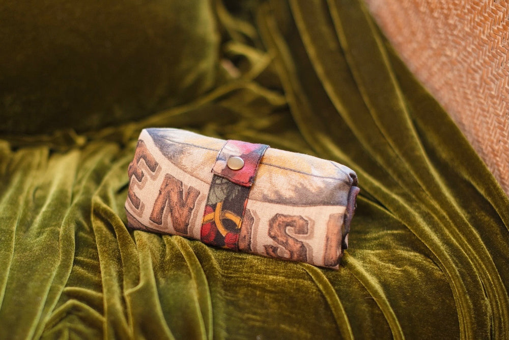 
                  
                    Model holding Friendship Love and Truth tote featuring historic symbols of cooperation, teamwork, eternal love, and truth from an 1880s print – Market of Stars.
                  
                