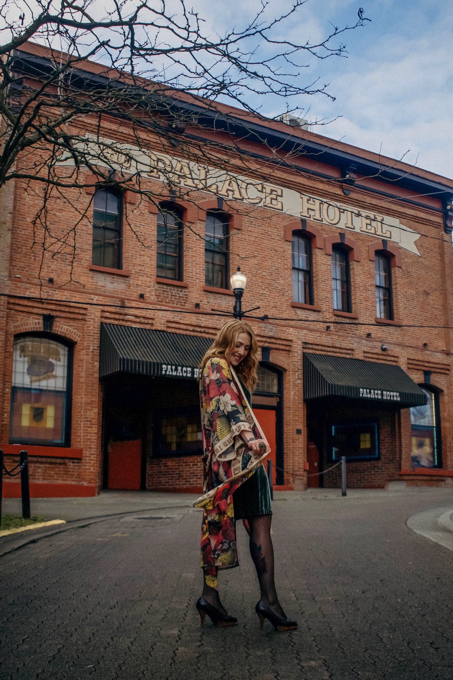 Model wearing our long, eclectic opera duster featuring vintage symbols of love, kindness, and truth in a bold archive-inspired print with removable belt – Market of Stars.