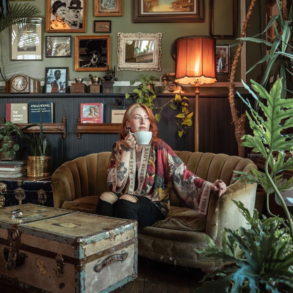 
                  
                    Model wearing our cropped kimono featuring historic symbols of friendship, love, and truth with archive-inspired wood-grain trim and romantic vintage details – Market of Stars.
                  
                