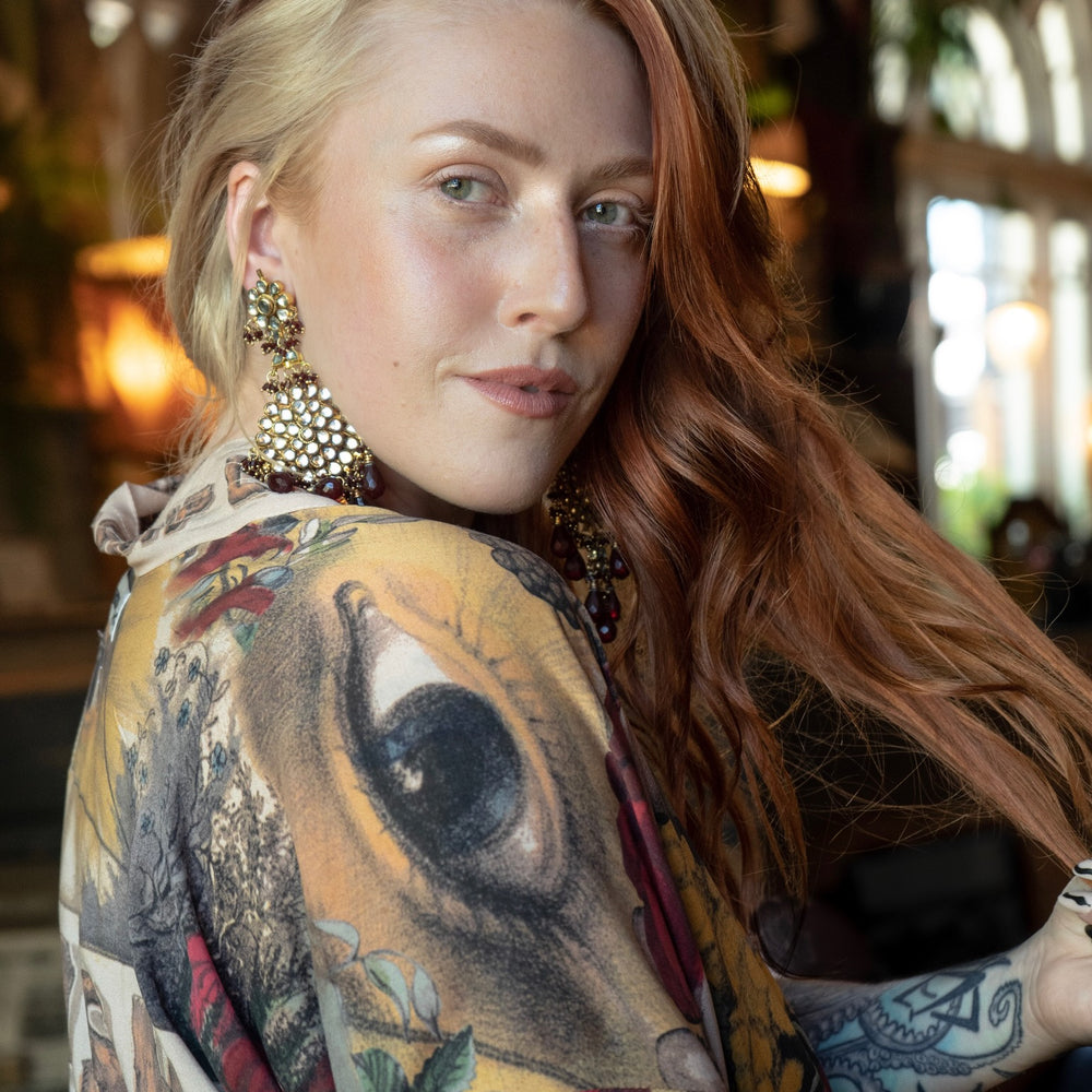 
                  
                    Model wearing our cropped kimono featuring historic symbols of friendship, love, and truth with archive-inspired wood-grain trim and romantic vintage details – Market of Stars.
                  
                
