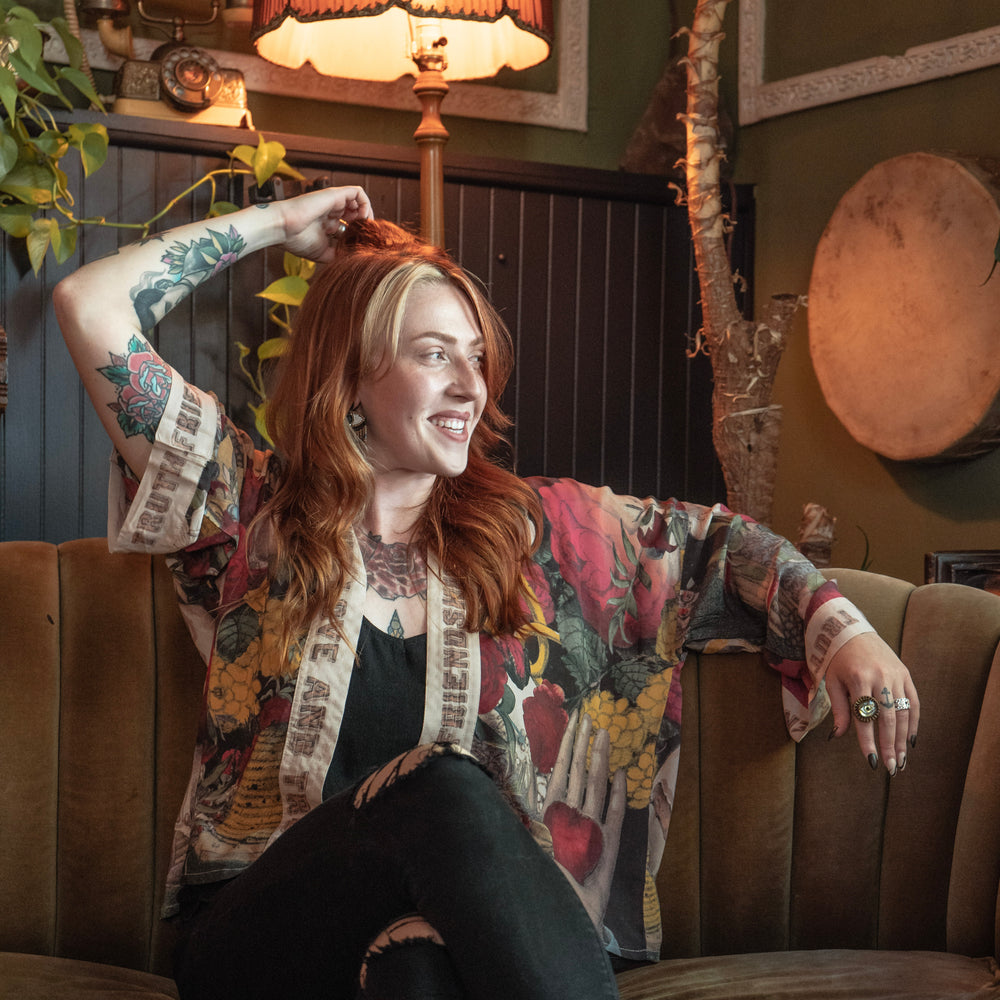 
                  
                    Model wearing our cropped kimono featuring historic symbols of friendship, love, and truth with archive-inspired wood-grain trim and romantic vintage details – Market of Stars.
                  
                
