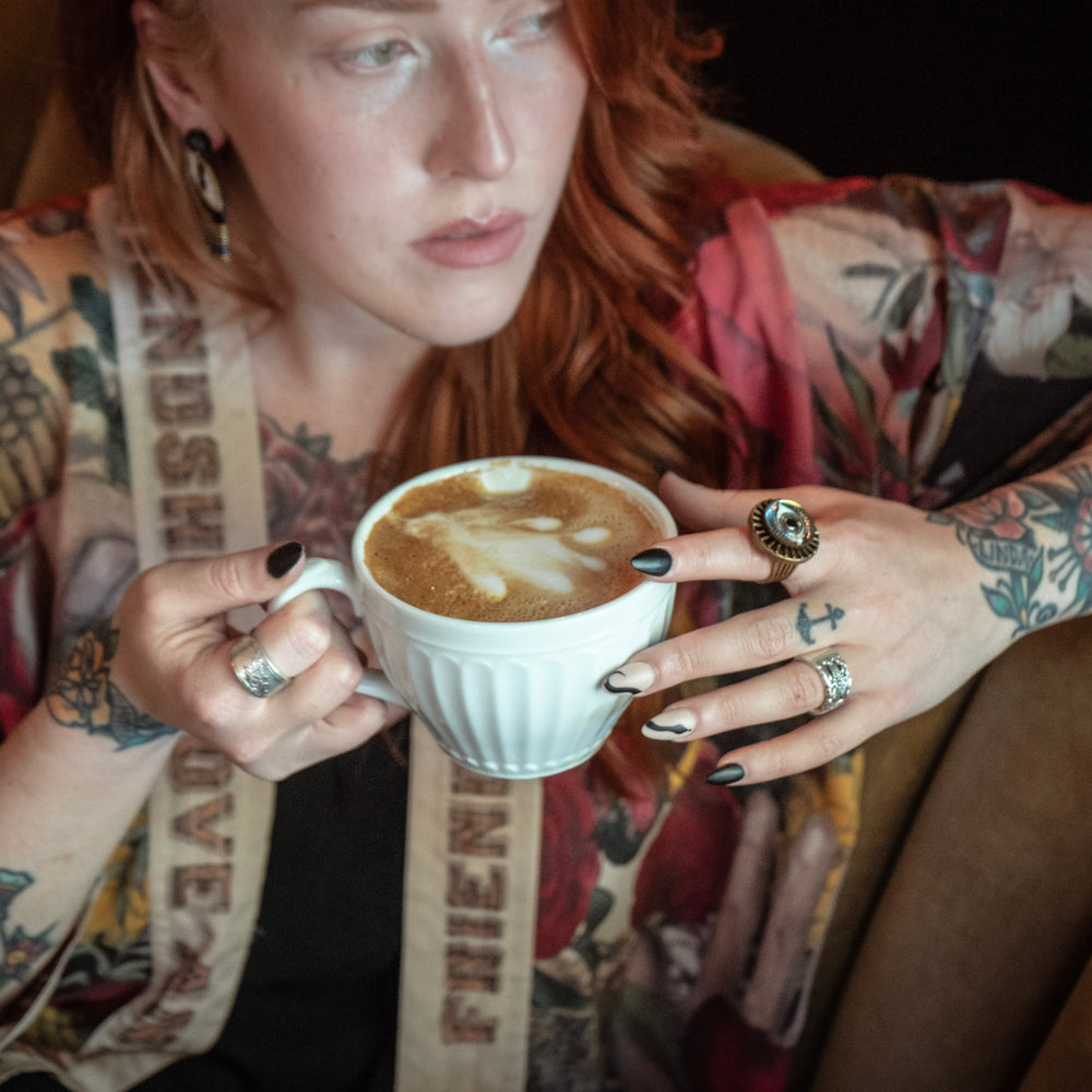 
                  
                    Model wearing our cropped kimono featuring historic symbols of friendship, love, and truth with archive-inspired wood-grain trim and romantic vintage details – Market of Stars.
                  
                