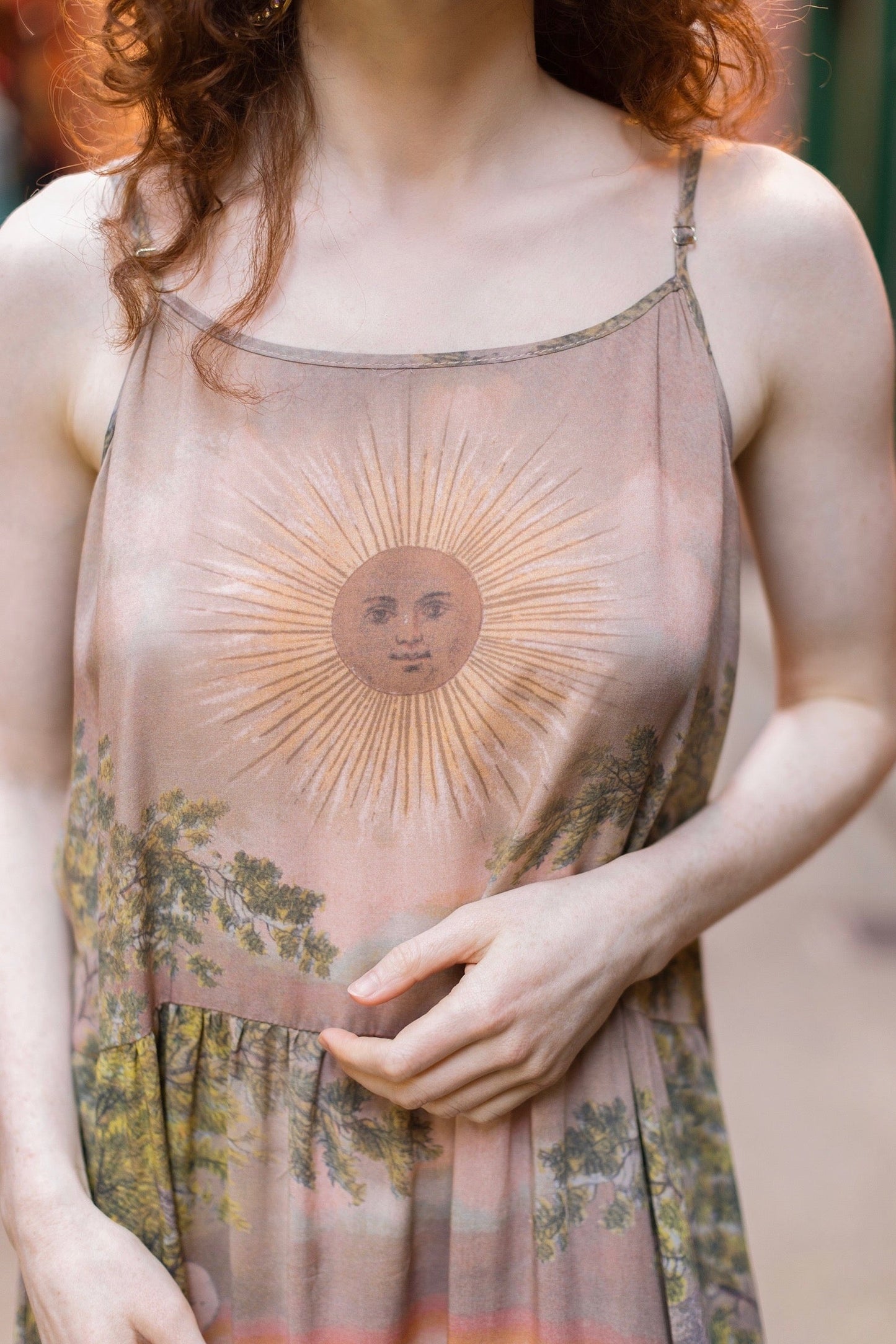 Model wearing sun-washed Bohéme slip dress featuring historic symbols of friendship, love, and truth in soft lavender, sage, gold, and aqua – Market of Stars.