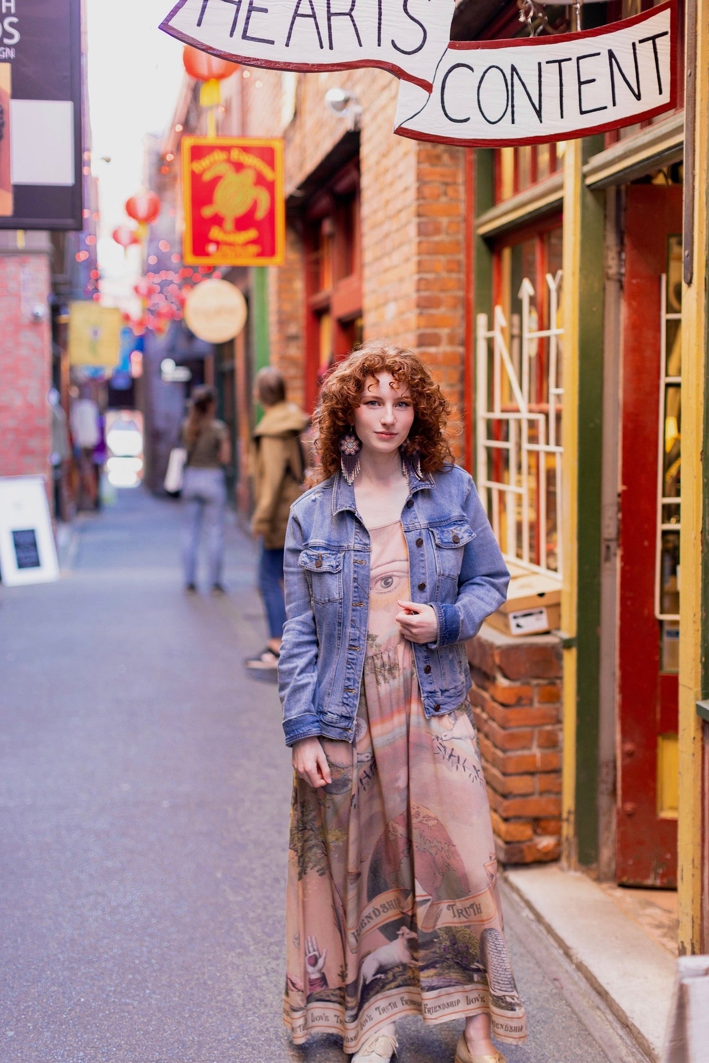 Model wearing sun-washed Bohéme slip dress featuring historic symbols of friendship, love, and truth in soft lavender, sage, gold, and aqua – Market of Stars.