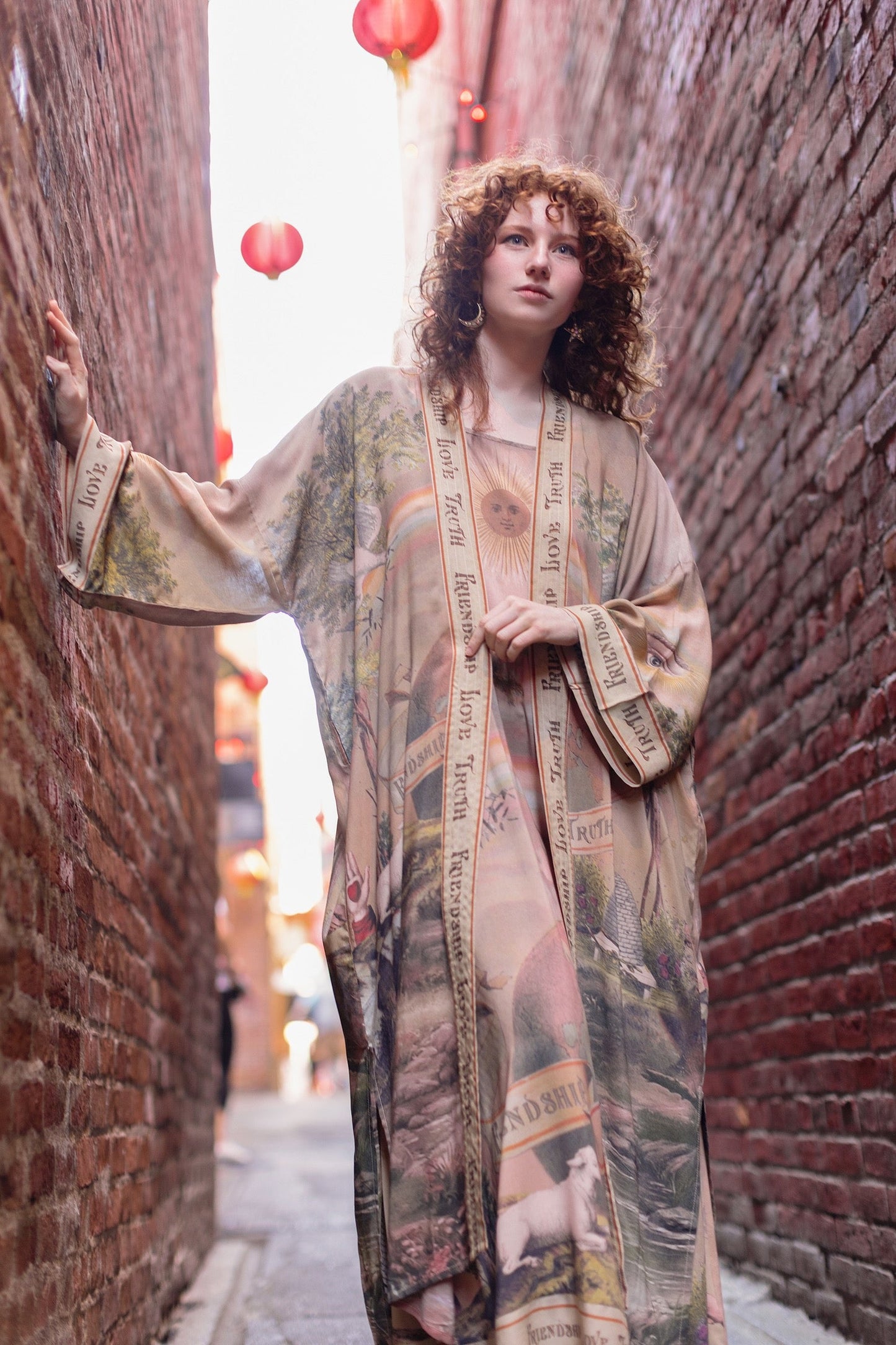 Model wearing sun-washed vintage-inspired Opera Duster featuring symbols of friendship, love, and truth in soft lavender, sage, gold, and aqua – Market of Stars