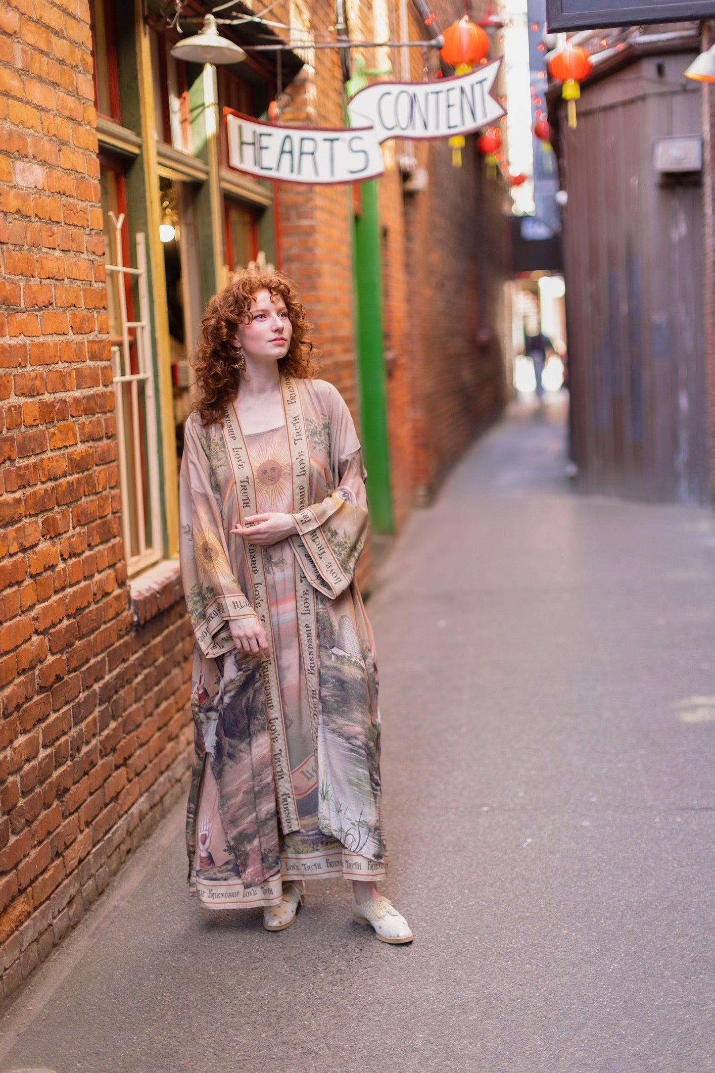 Model wearing sun-washed vintage-inspired Opera Duster featuring symbols of friendship, love, and truth in soft lavender, sage, gold, and aqua – Market of Stars