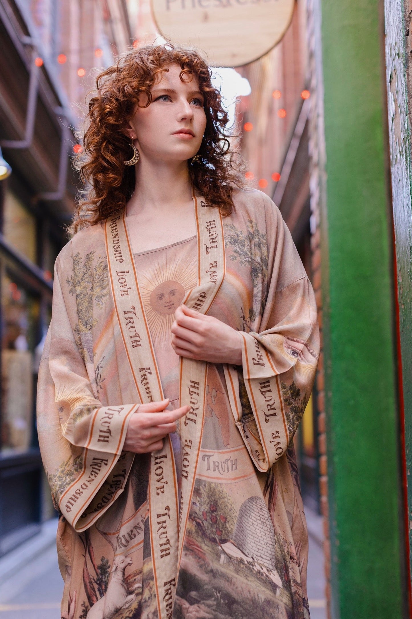 Model wearing sun-washed vintage-inspired Opera Duster featuring symbols of friendship, love, and truth in soft lavender, sage, gold, and aqua – Market of Stars