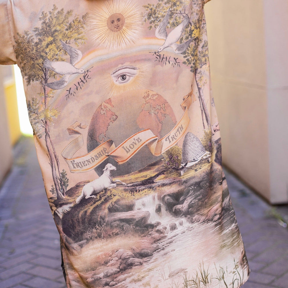 
                  
                    Model wearing sun-washed vintage-inspired Opera Duster featuring symbols of friendship, love, and truth in soft lavender, sage, gold, and aqua – Market of Stars
                  
                