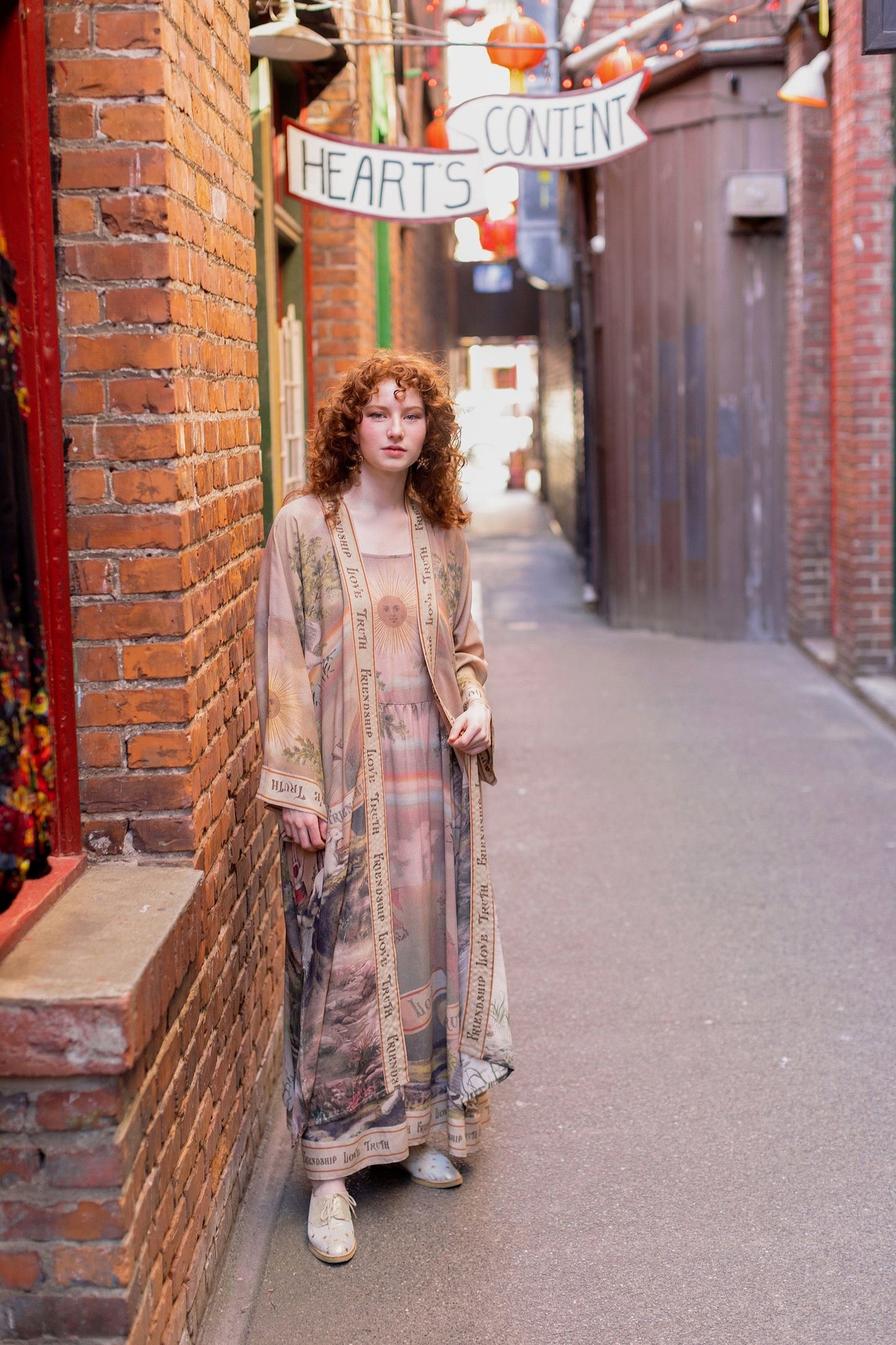 Model wearing sun-washed vintage-inspired Opera Duster featuring symbols of friendship, love, and truth in soft lavender, sage, gold, and aqua – Market of Stars